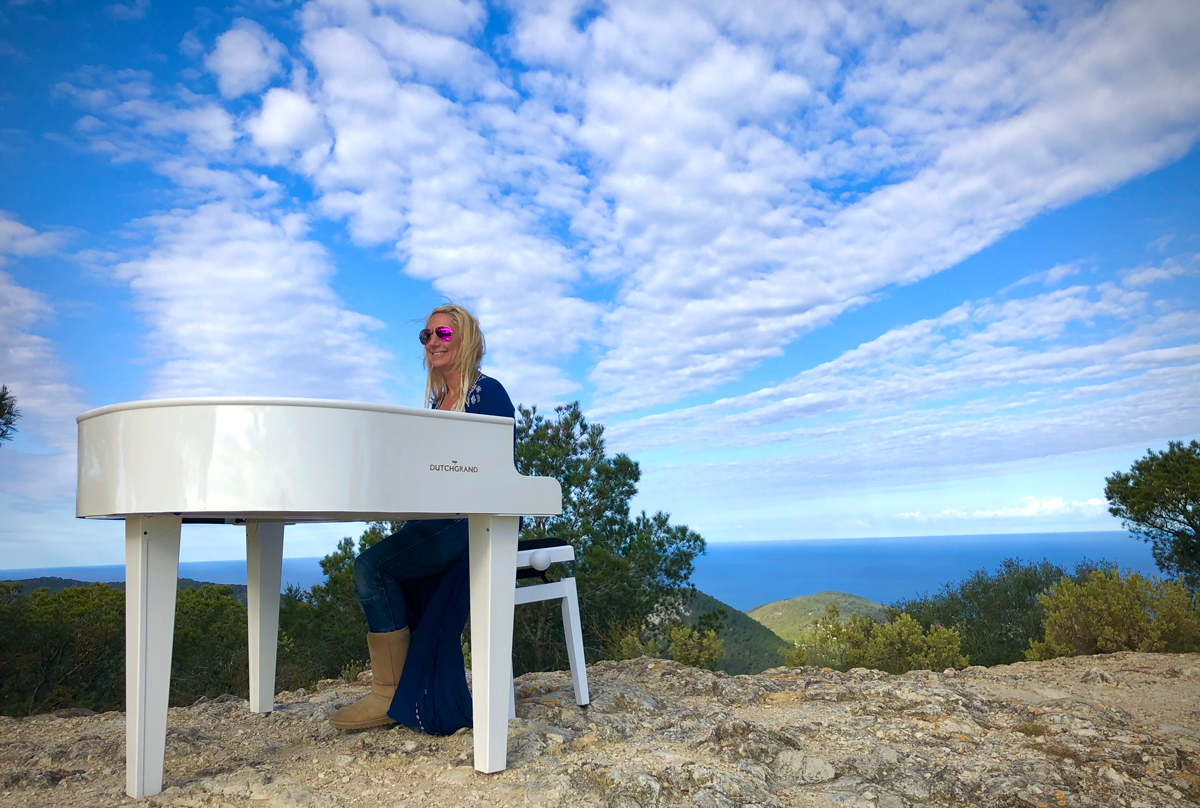 Ibiza wedding music pianist NINA playing her white grand piano at Sa Talaia - the highest point in Ibiza.