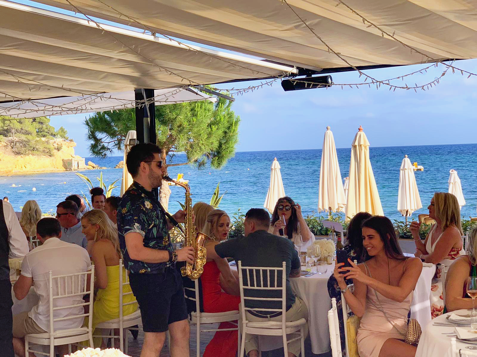 Ibiza Saxophonist playing at Pura Vida for meal.